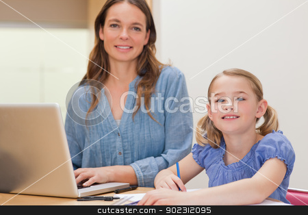 To use this stock image in your creative project, please select the size you need over to the right and click the "Add to Cart" button.
Your downloaded image will come with the Cutcaster watermark removed so don’t worry about the watermark you see on this page. Girl doing her homework while her mother is using notebook stock photo, Girl doing her homework while her mother is using notebook in a kitchen by Wavebreak Media