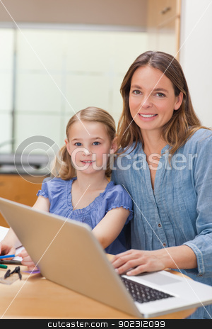 To use this stock image in your creative project, please select the size you need over to the right and click the "Add to Cart" button.
Your downloaded image will come with the Cutcaster watermark removed so don’t worry about the watermark you see on this page. Portrait of a girl doing her homework while her mother is workin stock photo, Portrait of a girl doing her homework while her mother is working with laptop in a kitchen by Wavebreak Media