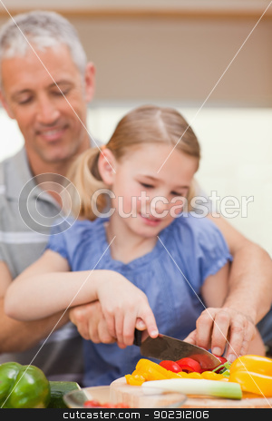 To use this stock image in your creative project, please select the size you need over to the right and click the "Add to Cart" button.
Your downloaded image will come with the Cutcaster watermark removed so don’t worry about the watermark you see on this page. Portrait of a father slicing pepper with his daughter stock photo, Portrait of a father slicing pepper with his daughter in a kitchen by Wavebreak Media