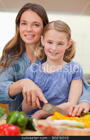 To use this stock image in your creative project, please select the size you need over to the right and click the "Add to Cart" button.
Your downloaded image will come with the Cutcaster watermark removed so don’t worry about the watermark you see on this page. Portrait of a woman slicing bell pepper with her daughter stock photo, Portrait of a woman slicing bell pepper with her daughter in a kitchen by Wavebreak Media