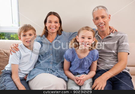 To use this stock image in your creative project, please select the size you need over to the right and click the "Add to Cart" button.
Your downloaded image will come with the Cutcaster watermark removed so don’t worry about the watermark you see on this page. Family sitting on a sofa stock photo, Family sitting on a sofa while looking at the camera by Wavebreak Media