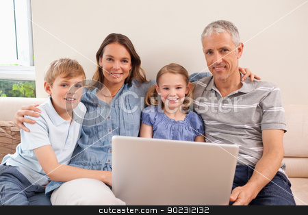 To use this stock image in your creative project, please select the size you need over to the right and click the "Add to Cart" button.
Your downloaded image will come with the Cutcaster watermark removed so don’t worry about the watermark you see on this page. Smiling family sitting on a sofa using a notebook stock photo, Smiling family sitting on a sofa using a notebook in a living room by Wavebreak Media