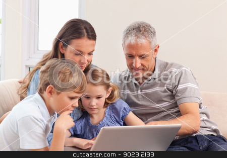 To use this stock image in your creative project, please select the size you need over to the right and click the "Add to Cart" button.
Your downloaded image will come with the Cutcaster watermark removed so don’t worry about the watermark you see on this page. Happy family sitting on a sofa using a notebook stock photo, Happy family sitting on a sofa using a notebook in a living room by Wavebreak Media
