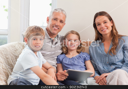 To use this stock image in your creative project, please select the size you need over to the right and click the "Add to Cart" button.
Your downloaded image will come with the Cutcaster watermark removed so don’t worry about the watermark you see on this page. Smiling family using a tablet computer stock photo, Smiling family using a tablet computer in a living room by Wavebreak Media