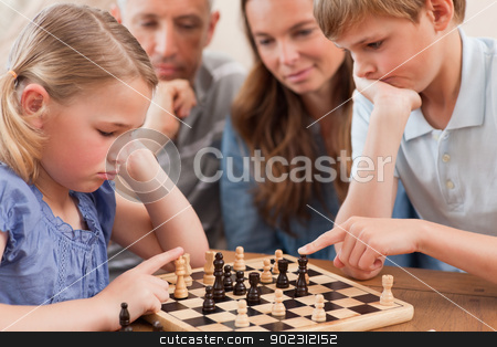 To use this stock image in your creative project, please select the size you need over to the right and click the "Add to Cart" button.
Your downloaded image will come with the Cutcaster watermark removed so don’t worry about the watermark you see on this page. Close up of children playing chess in front of their parents stock photo, Close up of children playing chess in front of their parents in a living room by Wavebreak Media