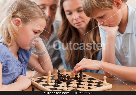 To use this stock image in your creative project, please select the size you need over to the right and click the "Add to Cart" button.
Your downloaded image will come with the Cutcaster watermark removed so don’t worry about the watermark you see on this page. Close up of serious children playing chess in front of their par stock photo, Close up of serious children playing chess in front of their parents in a living room by Wavebreak Media