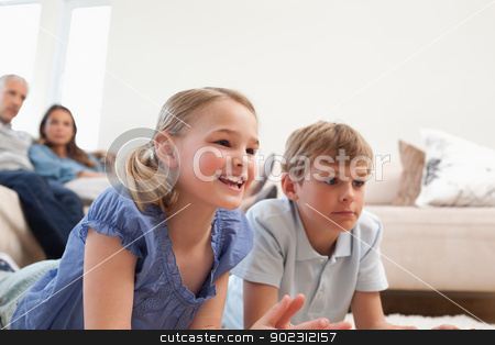To use this stock image in your creative project, please select the size you need over to the right and click the "Add to Cart" button.
Your downloaded image will come with the Cutcaster watermark removed so don’t worry about the watermark you see on this page. Children playing video games while their parents are watching stock photo, Children playing video games while their parents are watching in a living room by Wavebreak Media
