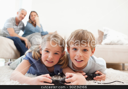 To use this stock image in your creative project, please select the size you need over to the right and click the "Add to Cart" button.
Your downloaded image will come with the Cutcaster watermark removed so don’t worry about the watermark you see on this page. Playful children playing video games with their parents on the b stock photo, Playful children playing video games with their parents on the background in a living room by Wavebreak Media