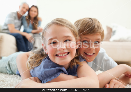To use this stock image in your creative project, please select the size you need over to the right and click the "Add to Cart" button.
Your downloaded image will come with the Cutcaster watermark removed so don’t worry about the watermark you see on this page. Happy siblings posing on a carpet with their parents on the back stock photo, Happy siblings posing on a carpet with their parents on the background in a living room by Wavebreak Media