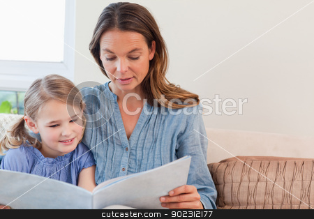 To use this stock image in your creative project, please select the size you need over to the right and click the "Add to Cart" button.
Your downloaded image will come with the Cutcaster watermark removed so don’t worry about the watermark you see on this page. Mother reading a book to her daughter stock photo, Mother reading a book to her daughter in a living room by Wavebreak Media