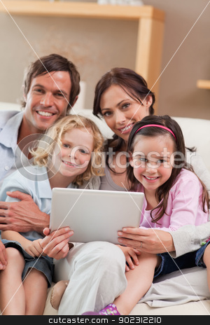 To use this stock image in your creative project, please select the size you need over to the right and click the "Add to Cart" button.
Your downloaded image will come with the Cutcaster watermark removed so don’t worry about the watermark you see on this page. Portrait of a family using a tablet computer stock photo, Portrait of a family using a tablet computer in a living room by Wavebreak Media