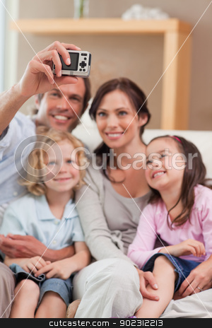 To use this stock image in your creative project, please select the size you need over to the right and click the "Add to Cart" button.
Your downloaded image will come with the Cutcaster watermark removed so don’t worry about the watermark you see on this page. Portrait of a father taking a picture of his family stock photo, Portrait of a father taking a picture of his family in a living room by Wavebreak Media