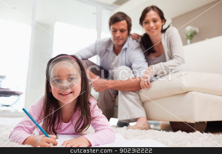 To use this stock image in your creative project, please select the size you need over to the right and click the "Add to Cart" button.
Your downloaded image will come with the Cutcaster watermark removed so don’t worry about the watermark you see on this page. Girl drawing with her parents in the background stock photo, Girl drawing with her parents in the background while lying on a carpet by Wavebreak Media