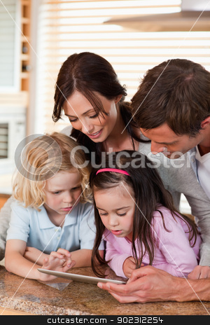 To use this stock image in your creative project, please select the size you need over to the right and click the "Add to Cart" button.
Your downloaded image will come with the Cutcaster watermark removed so don’t worry about the watermark you see on this page. Portrait of a happy family using a tablet computer together stock photo, Portrait of a happy family using a tablet computer together in a kitchen by Wavebreak Media