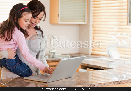 To use this stock image in your creative project, please select the size you need over to the right and click the "Add to Cart" button.
Your downloaded image will come with the Cutcaster watermark removed so don’t worry about the watermark you see on this page. Girl and her mother using a laptop stock photo, Girl and her mother using a laptop in a kitchen by Wavebreak Media