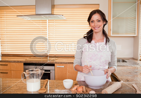 To use this stock image in your creative project, please select the size you need over to the right and click the "Add to Cart" button.
Your downloaded image will come with the Cutcaster watermark removed so don’t worry about the watermark you see on this page. Smiling woman baking stock photo, Smiling woman baking in her kitchen by Wavebreak Media