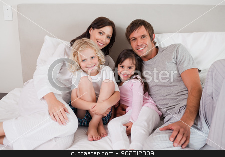 To use this stock image in your creative project, please select the size you need over to the right and click the "Add to Cart" button.
Your downloaded image will come with the Cutcaster watermark removed so don’t worry about the watermark you see on this page. Smiling family posing on a bed stock photo, Smiling family posing on a bed while looking at the camera by Wavebreak Media