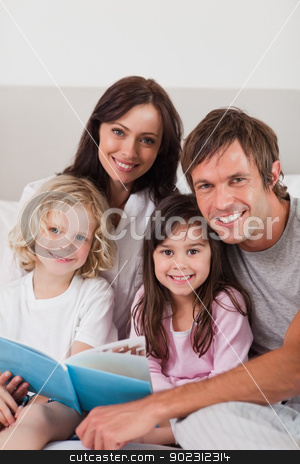 To use this stock image in your creative project, please select the size you need over to the right and click the "Add to Cart" button.
Your downloaded image will come with the Cutcaster watermark removed so don’t worry about the watermark you see on this page. Portrait of a happy family reading a book stock photo, Portrait of a happy family reading a book in a bedroom by Wavebreak Media
