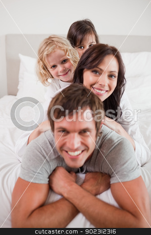 To use this stock image in your creative project, please select the size you need over to the right and click the "Add to Cart" button.
Your downloaded image will come with the Cutcaster watermark removed so don’t worry about the watermark you see on this page. Portrait of a family lying on each other stock photo, Portrait of a family lying on each other in a bedroom by Wavebreak Media