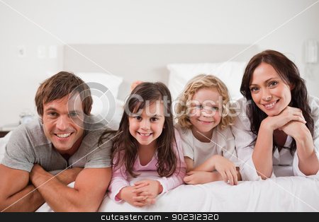 To use this stock image in your creative project, please select the size you need over to the right and click the "Add to Cart" button.
Your downloaded image will come with the Cutcaster watermark removed so don’t worry about the watermark you see on this page. Happy family lying in a bed stock photo, Happy family lying in a bed together by Wavebreak Media