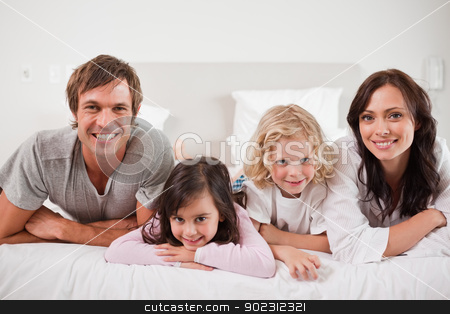 To use this stock image in your creative project, please select the size you need over to the right and click the "Add to Cart" button.
Your downloaded image will come with the Cutcaster watermark removed so don’t worry about the watermark you see on this page. Smiling family lying in a bed stock photo, Smiling family lying in a bed together by Wavebreak Media