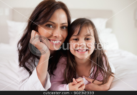 To use this stock image in your creative project, please select the size you need over to the right and click the "Add to Cart" button.
Your downloaded image will come with the Cutcaster watermark removed so don’t worry about the watermark you see on this page. Mother and her daughter lying on a bed stock photo, Mother and her daughter lying on a bed while looking at the camera by Wavebreak Media