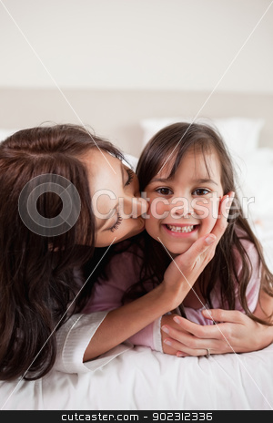 To use this stock image in your creative project, please select the size you need over to the right and click the "Add to Cart" button.
Your downloaded image will come with the Cutcaster watermark removed so don’t worry about the watermark you see on this page. Portrait of a mother kissing her daughter stock photo, Portrait of a mother kissing her daughter in a bedroom by Wavebreak Media