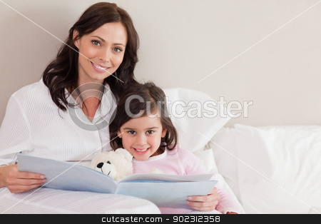 To use this stock image in your creative project, please select the size you need over to the right and click the "Add to Cart" button.
Your downloaded image will come with the Cutcaster watermark removed so don’t worry about the watermark you see on this page. Happy mother reading a story to her daughter stock photo, Happy mother reading a story to her daughter in a bedroom by Wavebreak Media