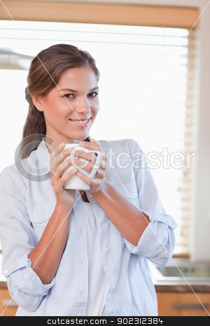 To use this stock image in your creative project, please select the size you need over to the right and click the "Add to Cart" button.
Your downloaded image will come with the Cutcaster watermark removed so don’t worry about the watermark you see on this page. Portrait of a woman holding a cup of tea stock photo, Portrait of a woman holding a cup of tea in her kitchen by Wavebreak Media