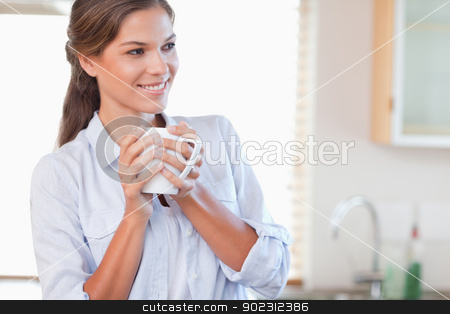 To use this stock image in your creative project, please select the size you need over to the right and click the "Add to Cart" button.
Your downloaded image will come with the Cutcaster watermark removed so don’t worry about the watermark you see on this page. Smiling woman holding a cup of tea stock photo, Smiling woman holding a cup of tea in her kitchen by Wavebreak Media