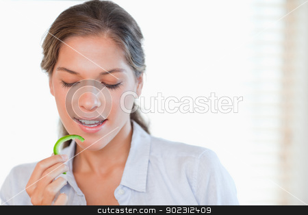 To use this stock image in your creative project, please select the size you need over to the right and click the "Add to Cart" button.
Your downloaded image will come with the Cutcaster watermark removed so don’t worry about the watermark you see on this page. Woman eating a slice of pepper stock photo, Woman eating a slice of pepper in her kitchen by Wavebreak Media