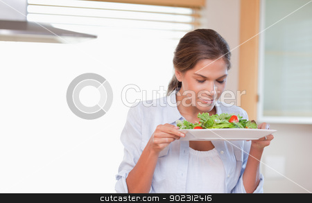 To use this stock image in your creative project, please select the size you need over to the right and click the "Add to Cart" button.
Your downloaded image will come with the Cutcaster watermark removed so don’t worry about the watermark you see on this page. Woman smelling a salad stock photo, Woman smelling a salad in her kitchen by Wavebreak Media