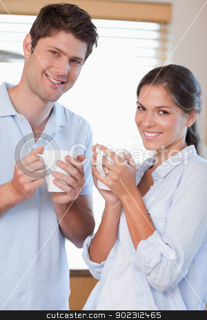 To use this stock image in your creative project, please select the size you need over to the right and click the "Add to Cart" button.
Your downloaded image will come with the Cutcaster watermark removed so don’t worry about the watermark you see on this page. Portrait of a couple drinking coffee stock photo, Portrait of a couple drinking coffee in their kitchen by Wavebreak Media