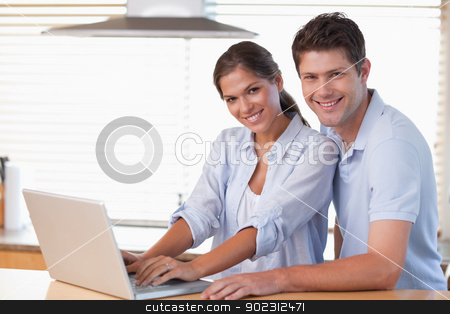 To use this stock image in your creative project, please select the size you need over to the right and click the "Add to Cart" button.
Your downloaded image will come with the Cutcaster watermark removed so don’t worry about the watermark you see on this page. Smiling couple using a laptop stock photo, Smiling couple using a laptop in their kitchen by Wavebreak Media