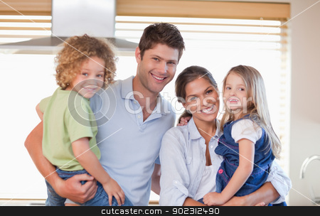 To use this stock image in your creative project, please select the size you need over to the right and click the "Add to Cart" button.
Your downloaded image will come with the Cutcaster watermark removed so don’t worry about the watermark you see on this page. Smiling family posing stock photo, Smiling family posing in their kitchen by Wavebreak Media