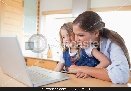 To use this stock image in your creative project, please select the size you need over to the right and click the "Add to Cart" button.
Your downloaded image will come with the Cutcaster watermark removed so don’t worry about the watermark you see on this page. Smiling mother and her daughter using a laptop stock photo, Smiling mother and her daughter using a laptop in their kitchen by Wavebreak Media