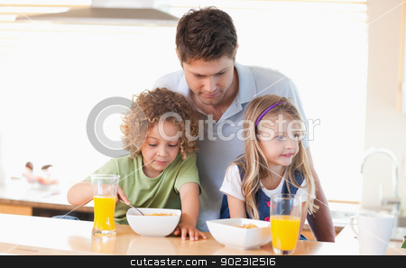 To use this stock image in your creative project, please select the size you need over to the right and click the "Add to Cart" button.
Your downloaded image will come with the Cutcaster watermark removed so don’t worry about the watermark you see on this page. Young father with his children having breakfast stock photo, Young father with his children having breakfast in their kitchen by Wavebreak Media