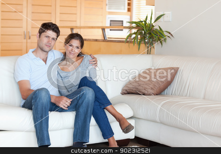 To use this stock image in your creative project, please select the size you need over to the right and click the "Add to Cart" button.
Your downloaded image will come with the Cutcaster watermark removed so don’t worry about the watermark you see on this page. Couple sitting on a couch stock photo, Couple sitting on a couch in their living room by Wavebreak Media