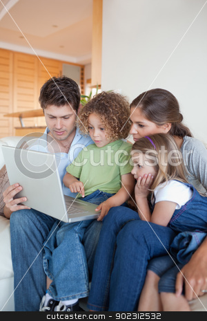 To use this stock image in your creative project, please select the size you need over to the right and click the "Add to Cart" button.
Your downloaded image will come with the Cutcaster watermark removed so don’t worry about the watermark you see on this page. Portrait of a family using a notebook stock photo, Portrait of a family using a notebook in their living room by Wavebreak Media