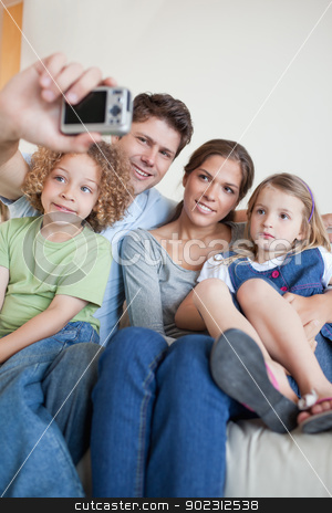 To use this stock image in your creative project, please select the size you need over to the right and click the "Add to Cart" button.
Your downloaded image will come with the Cutcaster watermark removed so don’t worry about the watermark you see on this page. Portrait of a family taking a photo of themselves stock photo, Portrait of a family taking a photo of themselves in their living room by Wavebreak Media