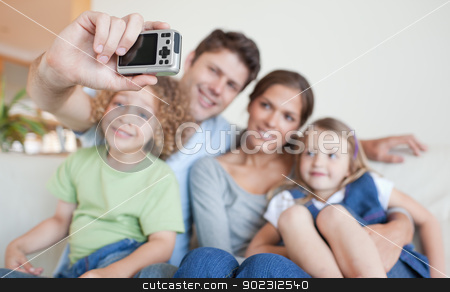 To use this stock image in your creative project, please select the size you need over to the right and click the "Add to Cart" button.
Your downloaded image will come with the Cutcaster watermark removed so don’t worry about the watermark you see on this page. Happy family taking a photo of themselves stock photo, Happy family taking a photo of themselves in their living room by Wavebreak Media