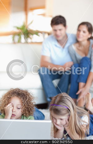 To use this stock image in your creative project, please select the size you need over to the right and click the "Add to Cart" button.
Your downloaded image will come with the Cutcaster watermark removed so don’t worry about the watermark you see on this page. Portrait of children using a laptop while their parents are watc stock photo, Portrait of children using a laptop while their parents are watching in their living room by Wavebreak Media