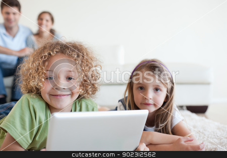 To use this stock image in your creative project, please select the size you need over to the right and click the "Add to Cart" button.
Your downloaded image will come with the Cutcaster watermark removed so don’t worry about the watermark you see on this page. Smiling children using a tablet computer while their happy paren stock photo, Smiling children using a tablet computer while their happy parents are watching in their living room by Wavebreak Media