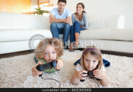 To use this stock image in your creative project, please select the size you need over to the right and click the "Add to Cart" button.
Your downloaded image will come with the Cutcaster watermark removed so don’t worry about the watermark you see on this page. Cute children playing video games while their parents are watchi stock photo, Cute children playing video games while their parents are watching in their living room by Wavebreak Media