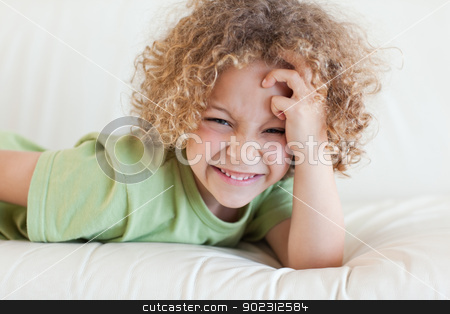 To use this stock image in your creative project, please select the size you need over to the right and click the "Add to Cart" button.
Your downloaded image will come with the Cutcaster watermark removed so don’t worry about the watermark you see on this page. Boy lying on a sofa stock photo, Boy lying on a sofa while looking at the camera by Wavebreak Media