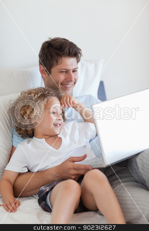 To use this stock image in your creative project, please select the size you need over to the right and click the "Add to Cart" button.
Your downloaded image will come with the Cutcaster watermark removed so don’t worry about the watermark you see on this page. Smiling father and child on bed with laptop stock photo, Smiling father and child on bed with laptop together by Wavebreak Media