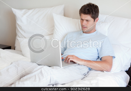To use this stock image in your creative project, please select the size you need over to the right and click the "Add to Cart" button.
Your downloaded image will come with the Cutcaster watermark removed so don’t worry about the watermark you see on this page. Man lying in bed with laptop stock photo, Man lying in bed with his laptop by Wavebreak Media
