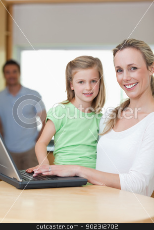 To use this stock image in your creative project, please select the size you need over to the right and click the "Add to Cart" button.
Your downloaded image will come with the Cutcaster watermark removed so don’t worry about the watermark you see on this page. Mother and daughter using notebook with father in the background stock photo, Mother and daughter using notebook together with father in the background by Wavebreak Media