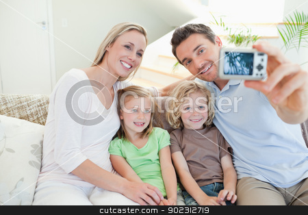 To use this stock image in your creative project, please select the size you need over to the right and click the "Add to Cart" button.
Your downloaded image will come with the Cutcaster watermark removed so don’t worry about the watermark you see on this page. Father taking family picture on sofa stock photo, Father taking family picture on the sofa by Wavebreak Media