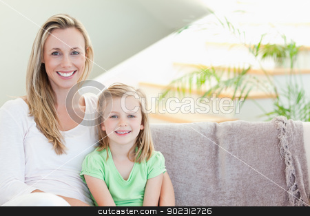 To use this stock image in your creative project, please select the size you need over to the right and click the "Add to Cart" button.
Your downloaded image will come with the Cutcaster watermark removed so don’t worry about the watermark you see on this page. Mother and daughter sitting on couch together stock photo, Mother and daughter sitting on the couch together by Wavebreak Media